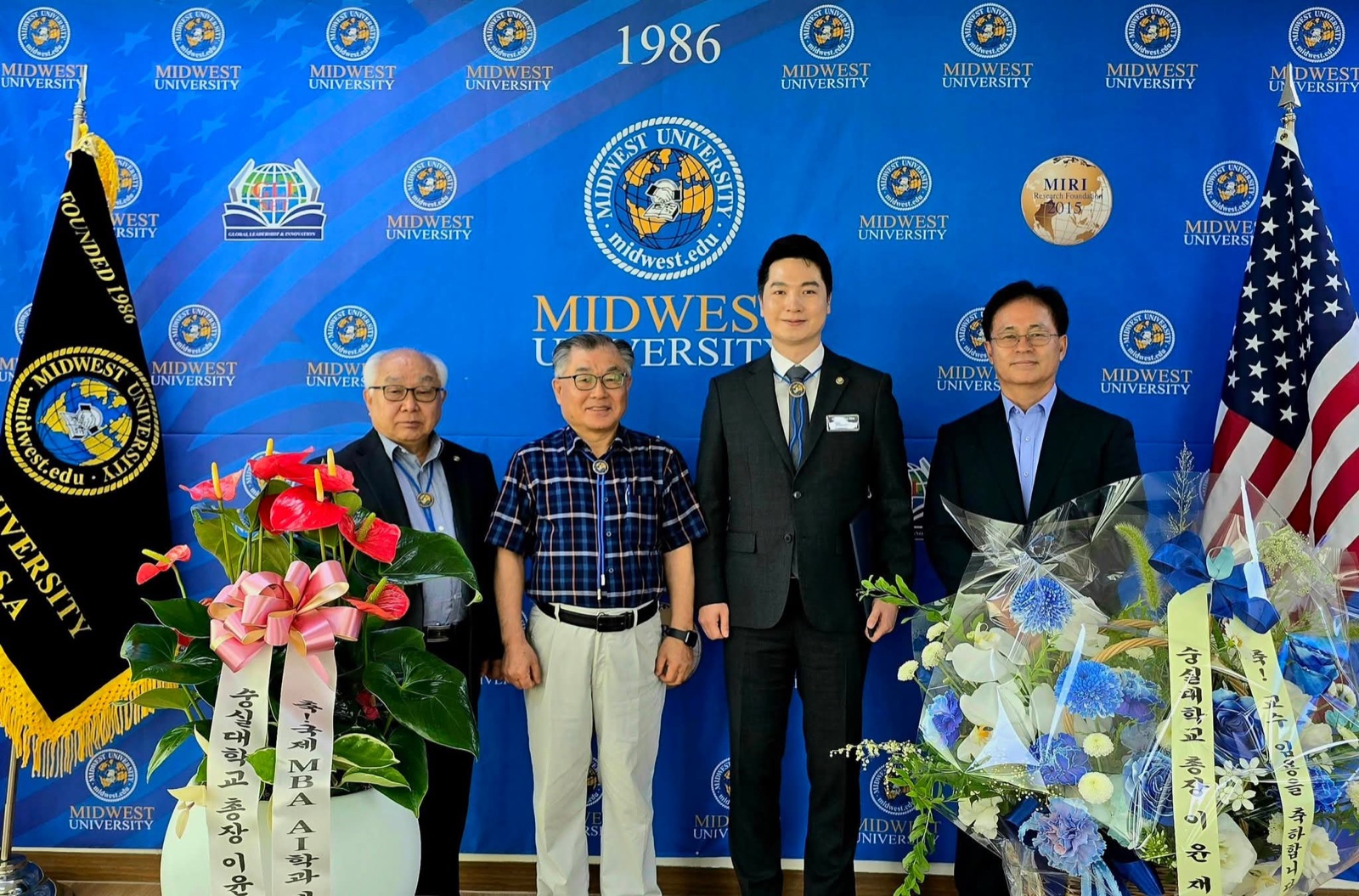 Jungsoo Kim with university officials in front of the Midwest University backdrop on the occasion of his appointment